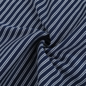 Macro shot of navy blue and white striped knit fabric showing fine texture and softness
