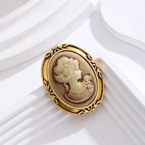 Vintage gold-toned oval brooch with beige female cameo relief and floral engraving