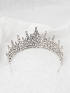 Close-up of silver princess crown tiara featuring intricate metalwork and sparkling rhinestones