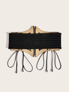 Detail showing vintage elastic waist belt with leather panel, front zipper and metal tassels
