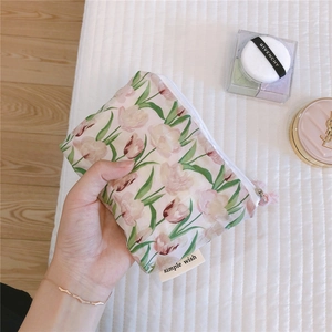 Detailed view of tulip floral cotton pouch with zipper and simple wish label