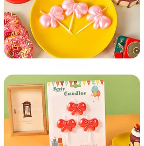 Detail of cute bow-shaped birthday candles in pink pearl and red for cake decoration