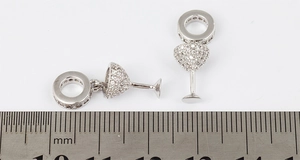 Macro shot of 18mm wine glass pendant with pave-set zircons next to a measuring scale