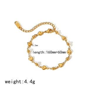 Detailed macro view of 18k gold heart chain with lobster clasp and adjustable length