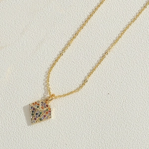 Detailed close-up of a 14K gold plated necklace featuring a colorful zircon kite pendant