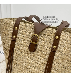 Close-up of golden hardware buckle and woven texture on a straw tote beach bag