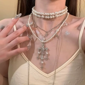 French vintage multilayer pearl necklace with silver cross pendant on elegant model