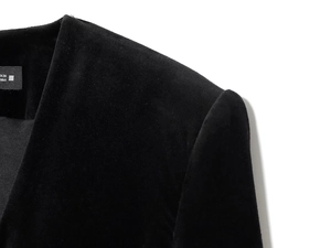 Detail shot of the V-neck tailoring and shoulder seam on this black velvet romper