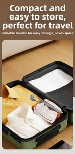 Compact portable steam iron with foldable handle stored inside a travel suitcase