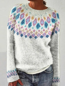 Detailed close-up of colorful geometric jacquard pattern on white knitted sweater collar