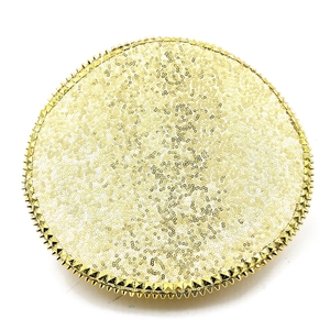 Detail of gold sequins and metallic cone studs on a circular bridal party hat accessory