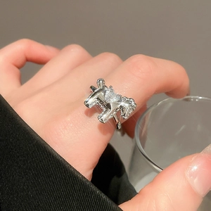 Detail of silver heart zircon ring featuring an intricate horse design for women