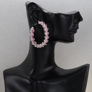 18K gold plated hoop earrings featuring pink heart-cut zircons on a black model