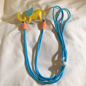 Detail of yellow elephant leather strap with blue adjustable woven cord and white buckle
