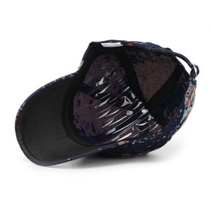 Detailed interior of vintage navy blue jacquard baseball cap with floral print texture