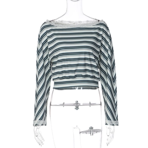 Detail of delicate white floral lace trim on the striped long sleeve crop top neckline