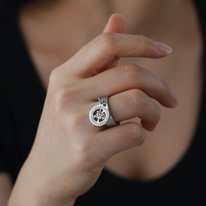 Silver stainless steel tree of life ring with crystal pendant on a model's finger