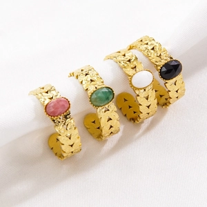 Set of four adjustable gold-plated steel rings featuring colorful oval gemstones