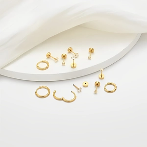 Minimalist gold stainless steel earring set featuring polished hoops and zircon studs