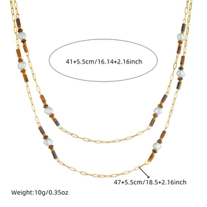Double-layered gold stainless steel necklace with tiger eye beads and pearls on white base