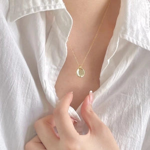 Minimalist 925 sterling silver necklace with a polished gold circular pendant on model