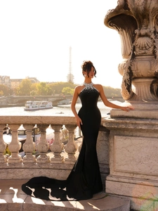 Detail of the halter neckline featuring sparkling crystals on a black mermaid evening gown