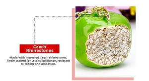 Detailed macro view of the green enamel apple pendant with Czech rhinestones