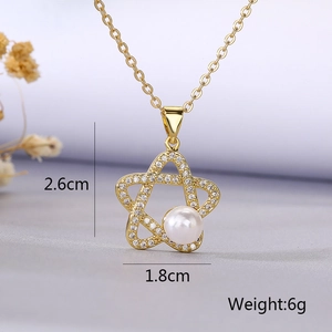 Detailed view of gold plated star necklace with zircon pavé and pearl, 2.6x1.8cm size