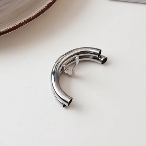 Detailed close-up of a silver metallic lava-style hair claw clip on a white background