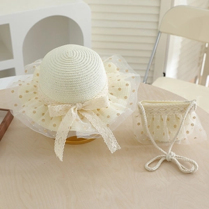 Detail of girls' woven straw hat and matching bag with lace bow and gold dot mesh