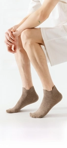 Detail view of khaki cotton ankle socks showing the anti-slip heel tab and flat stitching