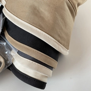 Close-up of cotton sun hats with contrast piping and twill fabric texture details