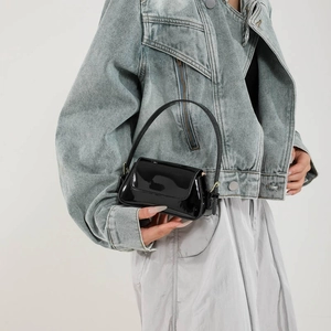 Sleek black patent leather baguette bag for women, minimalist glossy mini handbag style