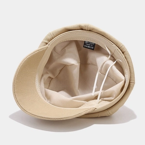 Beige corduroy newsboy cap for women featuring soft inner lining and detailed label