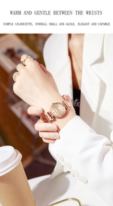 Rose gold quartz watch for women with minimalist dial on wrist in office setting