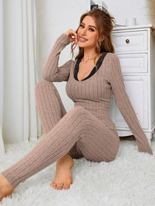 Close-up of dusty rose ribbed knit loungewear with black lace trim on V-neck top