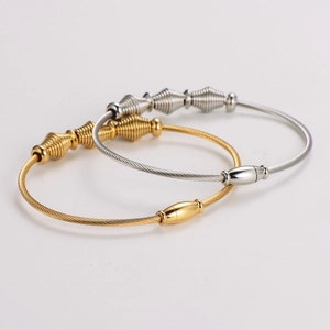 Minimalist steel cable wire bracelets in gold and silver finish with spiral cone accents