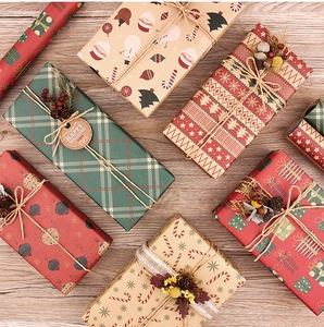 Detail of Christmas kraft wrapping paper with pine cones, berries and jute twine ties
