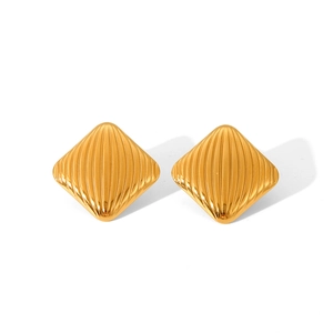 Detailed macro view of golden geometric rhombus earrings with vertical hammered texture