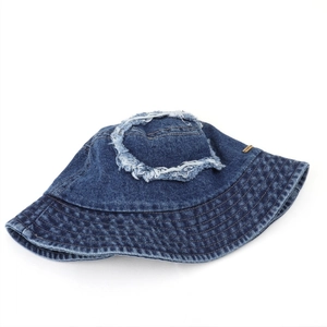 Detailed view of dark blue washed denim bucket hat with retro distressed frayed edge