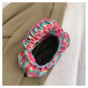 Macro view of pleated rainbow gradient satin shoulder bag with secure magnetic closure
