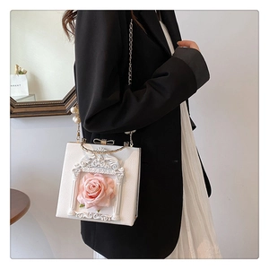 Detail of white baroque relief handbag with pink rose motif and pearl chain strap