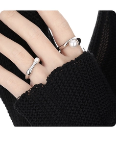 Detail of S925 sterling silver rings with white pearls and geometric design on hand