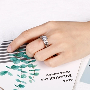 Detail of silver wavy ring with round zircon on hand, stylish stainless steel jewelry