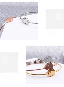 Macro shot of minimalist elephant bracelets in silver, gold, and rose gold finishes