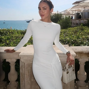 Detail of waist knot and ruching on a white slim fit long sleeve dress for women