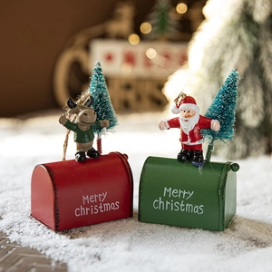 Christmas mailbox ornaments with Santa and reindeer figurines on snowy background