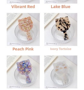 Detail of cute cat-shaped handheld makeup mirror with acetic acid tortoiseshell texture