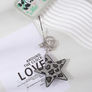 Star-shaped velvet keychain with leopard print rhinestones and silver metal hardware