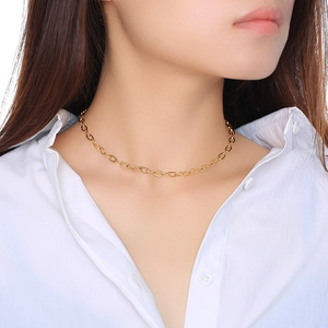 Detailed close-up of an elegant 18K gold plated stainless steel chain necklace on a model
